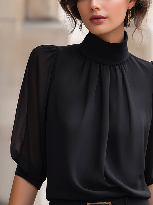 Blouse en mousseline à col montant et manches bouffantes