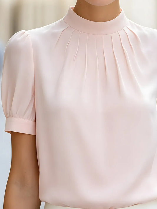 Blouse plissée à col montant et manches bouffantes