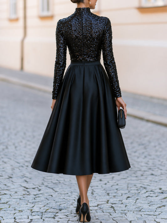 Robe de cocktail mi-longue en satin coupe trapèze à col montant, manches longues et sequins