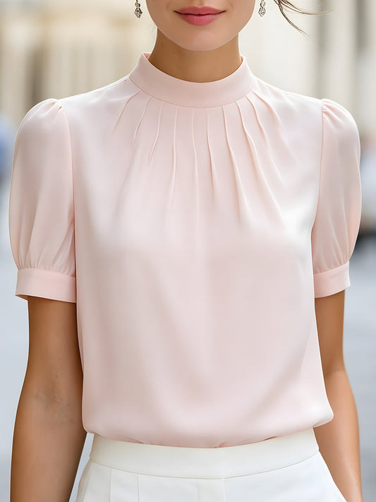 Blouse plissée à col montant et manches bouffantes